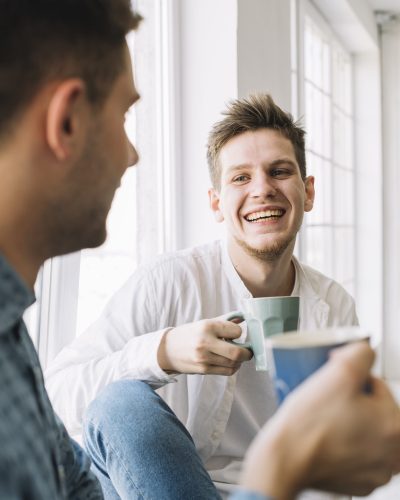 cheerful-man-having-morning-breakfast-with-his-friend