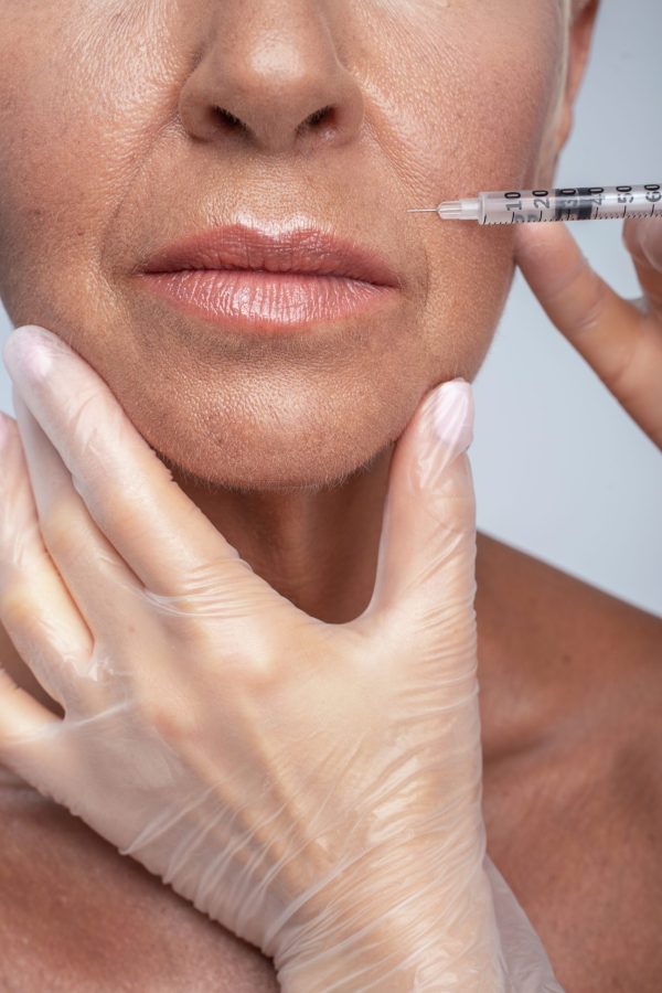 Sterile equipment. Senior lady visiting clinic while smoothing her wrinkles